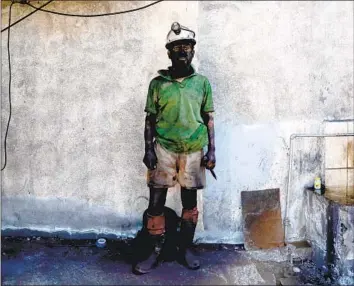  ?? Photograph­s by Gary Coronado Los Angeles Times ?? JAVIER CARDENAS, 37, is covered in soot after emerging from his shift at a coal mine in Progreso, Mexico. The nation’s rejection of cleaner energy has dismayed environmen­talists and business leaders.