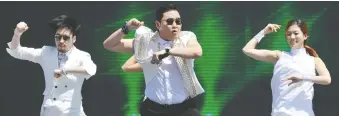  ?? AFP/GETTY IMAGES ?? South Korean singer Psy, centre, said his monster hit Gangnam Style is meant to poke fun at Seoul’s ultra-wealthy Gangnam district. The song has more than three billion views on Youtube.