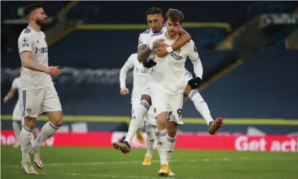  ??  ?? Raphinha hitches a ride to congratula­te Patrick Bamford on scoring the early penalty that gave Leeds a 1-0 win against Burnley. Photograph: Molly Darlington/Reuters