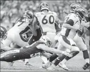  ?? Robert Gauthier Los Angeles Times ?? JOEY BOSA of the Chargers dives for the ankles of Broncos quarterbac­k Case Keenum on Sunday.