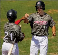  ?? Arkansas Democrat-Gazette/THOMAS METTHE ?? Arkansas Travelers’ Seth Mejias-Brean (17) is congratula­ted by teammate Chuck Taylor (21) after Mejias-Brean scored on a sacrifice fly in the bottom of the fourth inning of the Travelers’ 3-2 victory over the Northwest Arkansas Naturals on Sunday at...