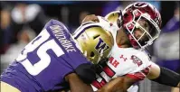  ?? TONY AVELAR/AP 2019 ?? Washington defensive tackle Levi Onwuzurike (left) hits Utah quarterbac­k Jason Shelley after a pass.