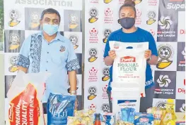  ?? Picture: FIJI FA MEDIA ?? Fiji FA vice-president Yogeshwar Singh and Tailevu-Naitasiri women’s rep Liku Tabua during the food ration distributi­on in Nausori.