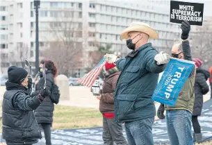  ?? JACQUELYN MARTIN THE ASSOCIATED PRESS ?? A supporter of U. S. President Donald Trump interrupts a group in Washington on Friday who were calling for Trump’s removal from office because of his role in rioting on Wednesday.