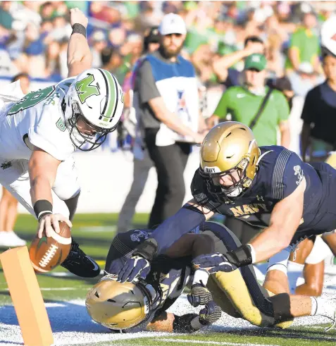  ?? TERRANCE WILLIAMS/AP ?? Marshall quarterbac­k Grant Wells runs the ball and is knocked out of bounds at the one yard line during the second half against Navy on Saturday.