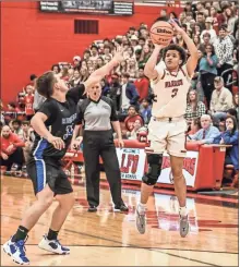  ?? Courtney Couey, Ringgold Tiger Shots ?? The LFO student section watches as Cameron Lay shoots the ball while guarded by Ringgold’s Cooper Sexton. The Warriors stayed unbeaten with an overtime victory.