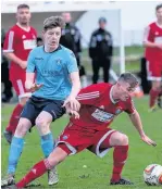  ?? Paul Watson ?? Town midfielder Tom Crawford ( left) battles for the ball in the game against AFC Darwen.