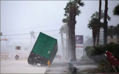  ?? The Associated Press ?? ONCOMING STORM: A power generator tips in front of Texas' CHRISTUS Spohn Hospital in Corpus Christi, Texas, as Hurricane Harvey hits Friday.