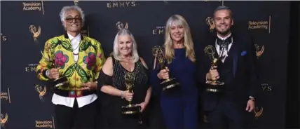  ?? PHOTOS BY RICHARD SHOTWELL/INVISION/THE ASSOCIATED PRESS ?? Bruce Samia, from left, Donna Anderson, Joy Zapata, and Pavy Olivarez pose in the press room with the award for outstandin­g hairstylin­g for a single-camera series for “Westworld” during night two of the Creative Arts Emmy Awards at the Microsoft...