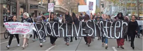  ?? MATT MILLS MCKNIGHT, EUROPEAN PRESSPHOTO AGENCY ?? Black Lives Matter protesters march through downtown Seattle on Nov. 14.