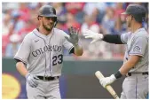  ?? LM OTERO/AP ?? Bryant, left, is congratula­ted by teammate Ryan McMahon after scoring on a triple by teammate C.J. Cron against the Rangers on Monday.