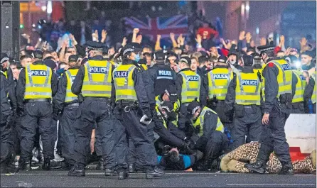  ?? Craig Foy/SNS ?? Police detain a man as Rangers fans gather at George Square in Glasgow on March 7
Picture:
