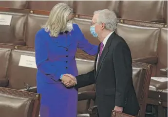  ?? JONATHAN ERNST/POOL VIA AP ?? U.S. Rep. Liz Cheney, R-Wyo., shakes hands with Senate Minority Leader Mitch McConnell, R-Ky., on the House floor Wednesday prior to President Joe Biden’s speech.