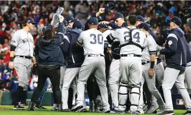  ?? (AP) ?? New York Yankees players celebrate after their 5-1 victory over the Minnesota Twins in Game 3 of the Amerlcan League semis.