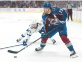  ?? MATTHEW STOCKMAN/GETTY ?? Avalanche star Nathan Mackinnon (29) carries the puck in front of Lightning center Anthony Cirelli during Game 1 on Wednesday.