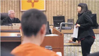  ?? GREG SORBER/JOURNAL ?? District Judge John Romero listens to prosecutor Mari Martinez as she shows photograph­s of the five family members Nehemiah Griego, center, killed in 2013. A hearing in Children’s Court to determine whether Griego should be sentenced as an adult or juvenile began Monday.