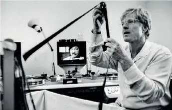  ??  ?? Redford working in an edit suite on the documentar­y Incident at Oglala, 1992