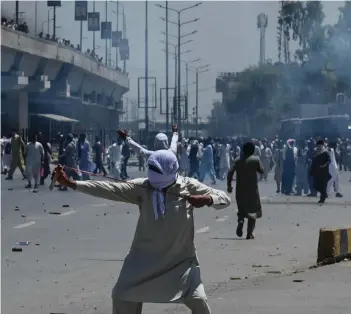  ?? Photo: Nampa ?? Nationwide protests… Pakistan Tehreek-e-Insaf (PTI) party activists and supporters of former Pakistan’s Prime Minister Imran Khan clash with police (unseen) during a protest against the arrest of their leader, in Peshawar on 10 May 2023.