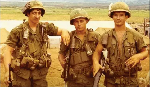  ?? Photo submitted ?? Longtime Siloam Springs veterinari­an Ken Leach (left) is pictured with fellow soldiers near the border between North and South Vietnam.