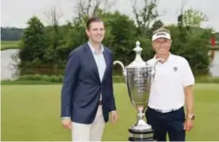  ??  ?? STERLING: Eric Trump (L) and Bernhard Langer pose with the trophy after Langer won the Senior PGA Championsh­ip at Trump National Golf Club on Sunday in Sterling, Virginia. — AFP