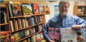  ?? SUBMITTED PHOTO ?? Eric Maywar, owner of Classics Bookstore in Trenton, holding a few books that Trenton kids can have for free.