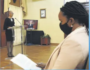  ?? PHOTOS COURTESY JIS ?? MINISTER OF EDUCATION, YOUTH AND INFORMATIO­N THE HON. FAYVAL WILLIAMS ADDRESSES THE BI-WEEKLY POST CABINET PRESS BRIEFING WHILE ACTING CHIEF EDUCATION OFFICER DR. KASAN TROUPE PERUSES THE STATEMENT