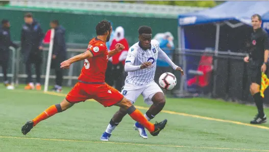  ?? PHOTOS: TONY LEWIS/CPL ?? Forge FC midfielder Fano Giuliano makes a tackle on FC Edmonton midfielder Allan Zebie during Saturday’s 1-1 Canadian Premier League draw at Clarke Stadium.