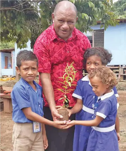  ?? Photo: Ministry of Forestry ?? Minister for Forestry, Honourable Osea Naiqamu with primary school students.