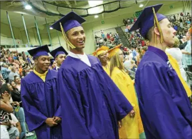  ?? PHOTOA BY LAUREN HALLIGAN —LHALLIGAN@DIGITALFIR­STMEDIA.COM ?? Smiling graduates walking into the Troy High School 2017 commenceme­nt ceremony on Sunday at Hudson Valley Community College in Troy.