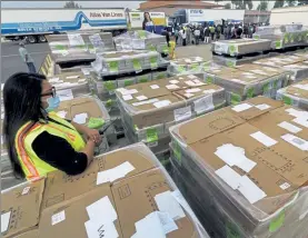  ?? AP ?? Pallets of ballots ready for mailing are shown to the media on Monday at the Orange County Registrar of Voters in Santa Ana, Calif.