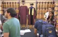  ??  ?? ASU students line up to purchase commenceme­nt regalia last week at a campus bookstore in Tempe.