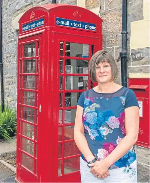  ??  ?? HANGING IN THERE: Caroline Breen at the ‘rescued’ phone booth in Tomintoul