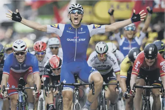  ??  ?? 2 Germany’s Marcel Kittel celebrates as he crosses the finish line in Liege ahead of Arnaud Demare, left, and Andre Greipel, right.