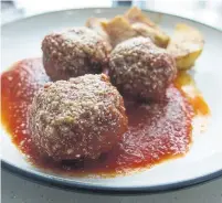  ??  ?? Ciao Amici meatballs come with straightfo­rward tomato sauce.