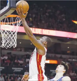  ?? AP PHOTO ?? Miami Heat guard Dion Waiters goes to the basket as Philadelph­ia 76ers forward Dario Saric defends.