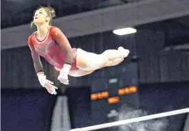  ?? [PHOTO BY NATE BILLINGS, THE OKLAHOMAN ARCHIVES] ?? OU’s Maggie Nichols competes on bars last February. The former U.S. national team gymnast and a sophomore at OU says she was sexually assaulted by former Team USA physician Larry Nassar and was the first to report the abuse to USA Gymnastics in 2015.