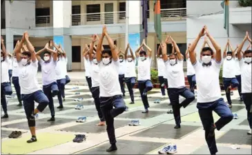  ?? AFP ?? Police in Bangladesh are using mass yoga sessions to boost their health and ward off Covid-19 after 6,000 officers in the country were infected.