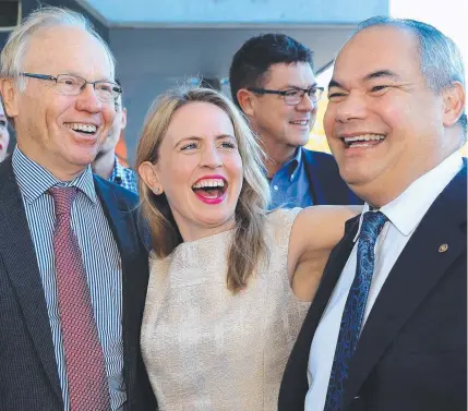  ??  ?? It’s one big love-in — or Kate will sort her boys out. Minister Kate Jones with Peter Beattie, left, and Tom Tate.