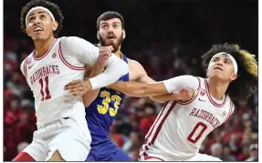  ?? (NWA Democrat-Gazette/Andy Shupe) ?? Arkansas forward Jalen Graham (11) and guard Anthony Black (0) defend against South Dakota State forward Broden Lien during the first half Wednesday at Walton Arena in Fayettevil­le. A solid effort on defense has helped the Razorbacks to a 3-0 start as they prepare to play in the Maui Invitation­al in Hawaii beginning Monday.