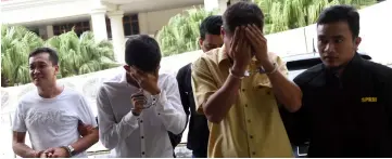  ??  ?? The three accused being brought out of the Sessions Court after sentencing. — Bernama photo