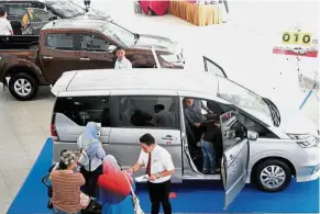  ??  ?? Losing momentum: Analysts expect loan growth to start to ease from next month as car sales fizzle out upon the introducti­on of the sales and service tax.