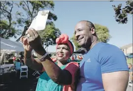  ?? Francine Orr Los Angeles Times ?? INGLEWOOD MAYOR James T. Butts Jr. poses for a selfie with Toni Malone at a block party. His recent home purchase in the city has raised some questions.