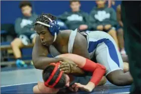  ?? PHOTOS BY SAM STEWART — DIGITAL FIRST MEDIA ?? Pottstown’s Isaiah Mayes works against his opponent at 182. Mayes pinned his opponent in 3:11.