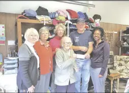  ?? Photo by Russ Collins ?? Washington Ladies Auxiliary volunteers (from left) Mary Collins, Shirley Franey, Louise Bondelid and Dorothy James present Washington Volunteer Fire and Rescue Chief Gary Jenkins a check for $10,000 — representi­ng a year's hard work by the volunteers,...