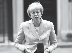  ?? Kirsty Wiggleswor­th/Associated Press ?? ■ Britain’s Prime Minister Theresa May makes a statement outside 10 Downing Street on Thursday in London.