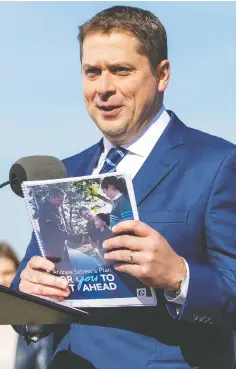  ?? CARLOS OSORIO / REUTERS ?? Conservati­ve Leader Andrew Scheer reveals his party’s platform
in Delta, B.C., on Friday — just 10 days before the election.