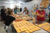  ?? CHRIS O’MEARA — THE ASSOCIATED PRESS ?? Volunteers with the Metropolit­an Ministries World Central kitchen in Tampa, Fla., prepare sandwiches on Friday that will go to Hurricane Ian survivors in Southwest Florida.