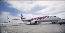  ?? THE CANADIAN PRESS FILE PHOTO ?? A Swoop Boeing 737, at Munro Internatio­nal Airport, is part of the fleet the airline launched in June.