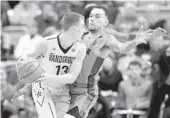  ?? MARK HUMPHREY/AP ?? Vanderbilt guard Riley LaChance looks to pass around Florida’s Chris Chiozza.