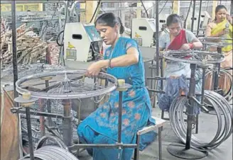  ?? HT FILE ?? ■ Workers on the job at one of Ludhiana’s many cycle manufactur­ing units, which form a big part of the state’s industry.